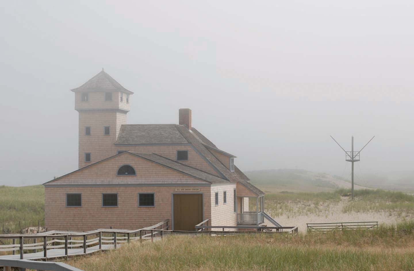 The Old Harbor Life-Saving Station in the dunes, shrouded in fog